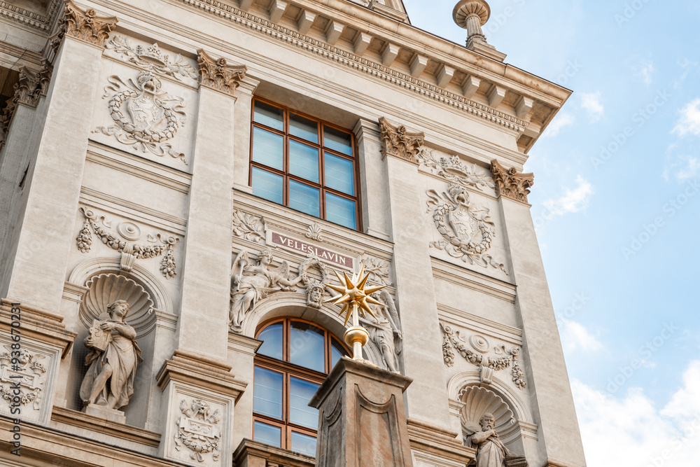 Fototapeta premium Prague, Czech Republic, May 12, 2024 : Gilded star on top of pillar in front of facade of Peoples Museum on famous Wenceslas Square in Prague in Czech Republic