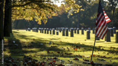 The image captures a poignant scene of an American flag placed at a veterans cemetery with sunlight filtering through trees