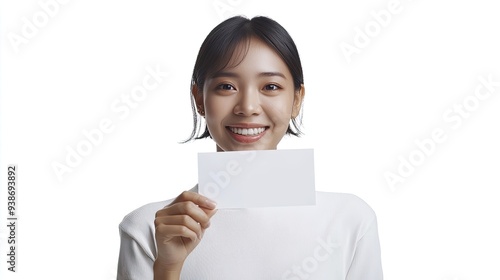 asian woman holding a blank card and smiling proudly