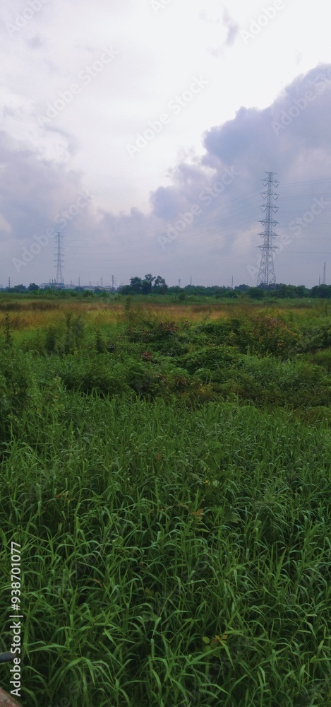 The natural scenery, green grass, natural river, houses, electric poles are very beautiful pictures. The natural scenery, green grass, natural river, houses, electric poles are very beautiful pictures.