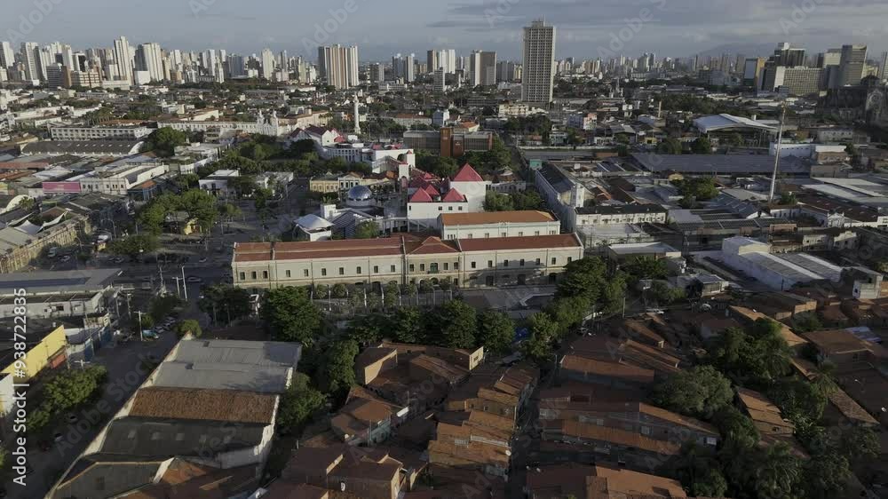 Drone flies south over Dragão do Mar complex toward Praça Cristo Redentor at sunset in Fortaleza, Ceará, Brazil