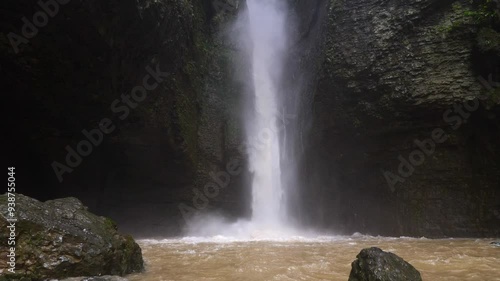 Waterfall in rainy season. Fast flowing waterfall among canyon. Soil and mud moving down after strong rain. Biggest water fall in Luyuanping, Enshi, Hubei, China.4k slow motion footage b roll shot. photo