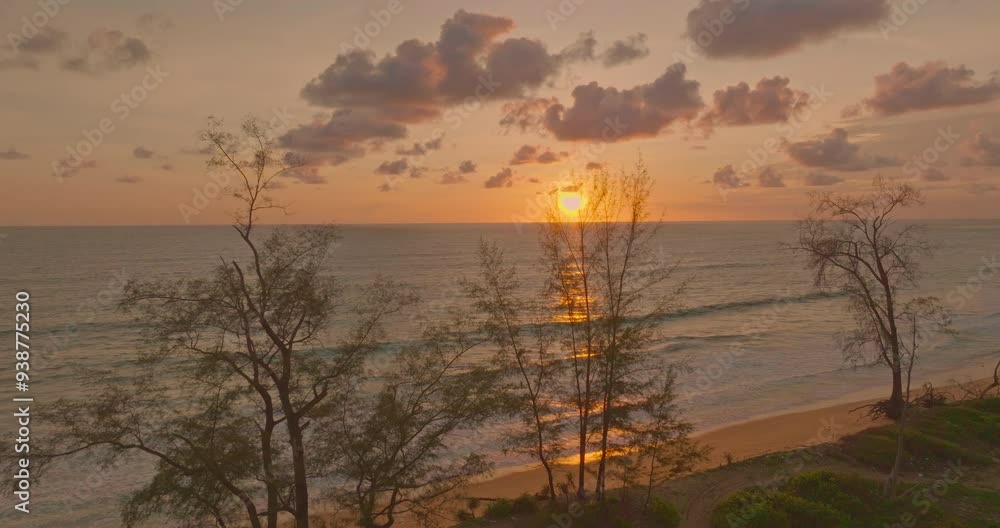 Aerial view a golden sunset over a tranquil tropical beach, framed by silhouetted trees. The vibrant colors of the setting sun reflect on the gentle waves, creating a peaceful and serene atmosphere Aerial view a golden sunset over a tranquil tropical beach, framed by silhouetted trees. The vibrant colors of the setting sun reflect on the gentle waves, creating a peaceful and serene atmosphere