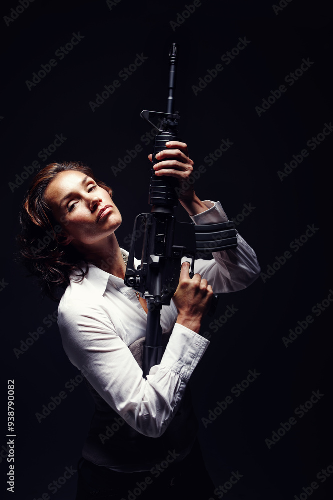 Woman, portrait and serious with rifle in studio for business security or company protection on black background. Female person, mafia or gun for corporate crime, corruption or white collar criminal Woman, portrait and serious with rifle in studio for business security or company protection on black background. Female person, mafia or gun for corporate crime, corruption or white collar criminal