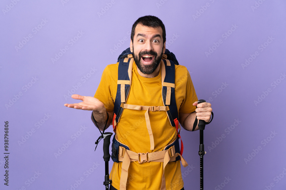 Caucasian handsome man with backpack and trekking poles over isolated background with shocked facial expression Caucasian handsome man with backpack and trekking poles over isolated background with shocked facial expression