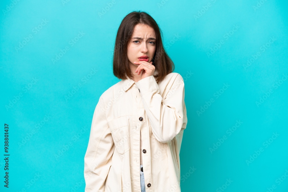 Young Ukrainian woman isolated on blue background having doubts Young Ukrainian woman isolated on blue background having doubts