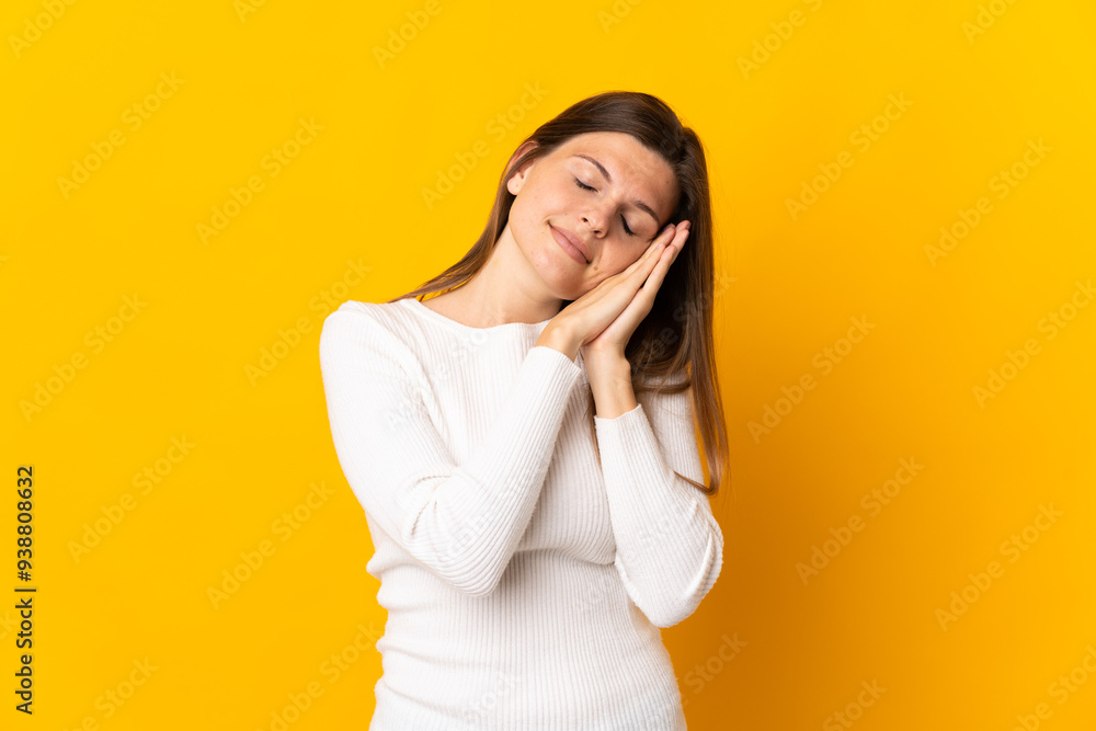 Young Slovak woman isolated on yellow background making sleep gesture in dorable expression Young Slovak woman isolated on yellow background making sleep gesture in dorable expression