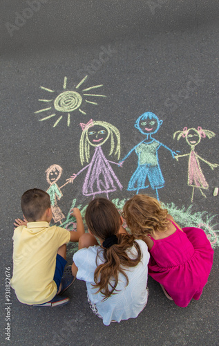 Fotografie children draw a family with chalk. Selective focus