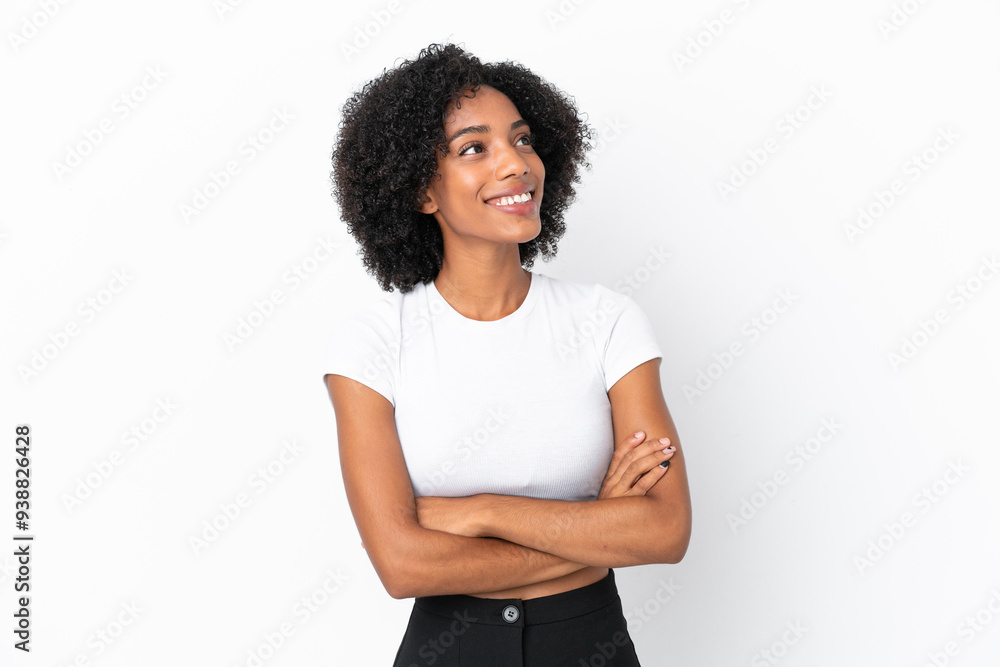 Young African American woman isolated on white background looking up while smiling Young African American woman isolated on white background looking up while smiling
