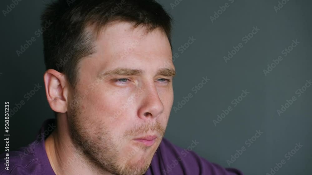 Young man puts sushi roll into mouth with chopsticks chewing. Guy tastes delicious Japanese dish with rich taste sitting at restaurant Young man puts sushi roll into mouth with chopsticks chewing. Guy tastes delicious Japanese dish with rich taste sitting at restaurant