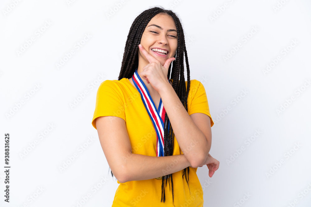Teenager girl with braids and medals over isolated pink background smiling Teenager girl with braids and medals over isolated pink background smiling
