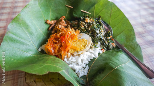 Traditional Indonesian culinary food. Food Rames rice or rice wrapped in teak leaves. Indonesian Street Food. photo