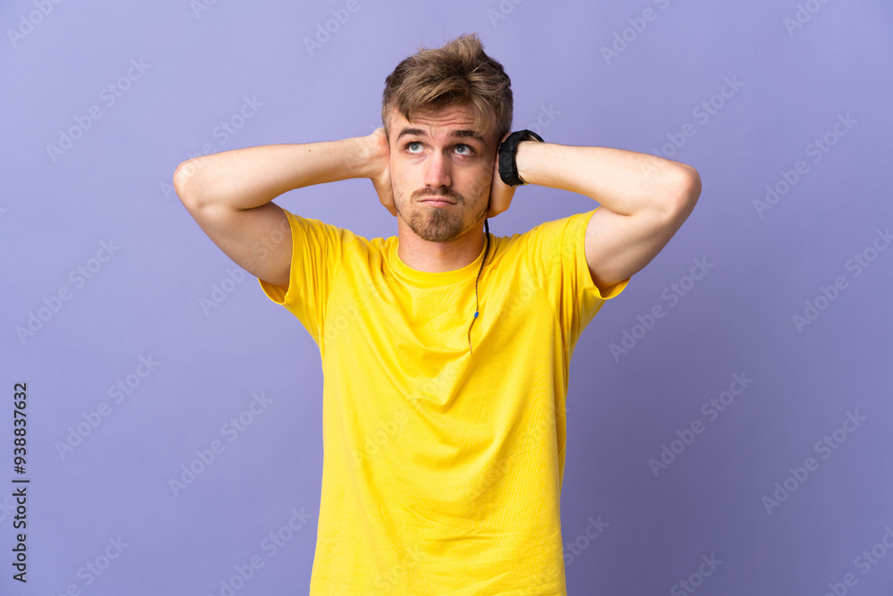 Young handsome blonde man isolated on purple background frustrated and covering ears Young handsome blonde man isolated on purple background frustrated and covering ears