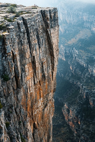 A far-off cliff face, with rugged textures and crevices 