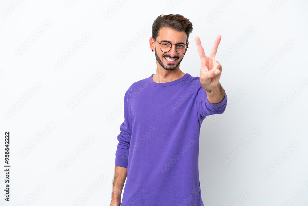 Young caucasian man isolated on white background smiling and showing victory sign Young caucasian man isolated on white background smiling and showing victory sign