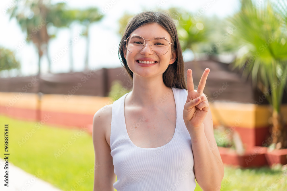 Young pretty woman at outdoors With glasses and doing OK sign Young pretty woman at outdoors With glasses and doing OK sign