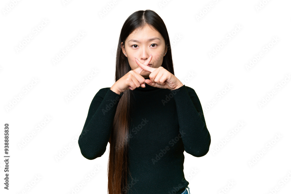 Young Asian woman over isolated chroma key background showing a sign of silence gesture Young Asian woman over isolated chroma key background showing a sign of silence gesture
