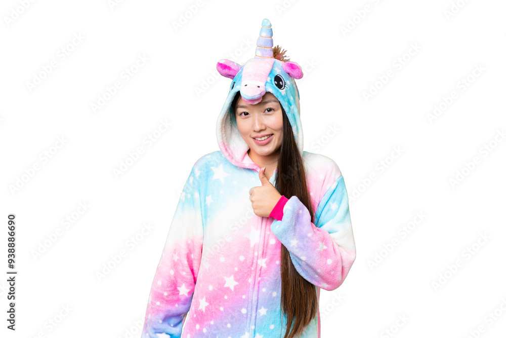 Young Asian woman with unicorn pajamas over isolated chroma key background giving a thumbs up gesture Young Asian woman with unicorn pajamas over isolated chroma key background giving a thumbs up gesture