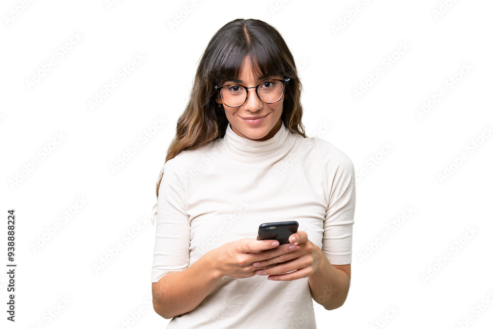 Young caucasian woman over isolated background sending a message with the mobile Young caucasian woman over isolated background sending a message with the mobile