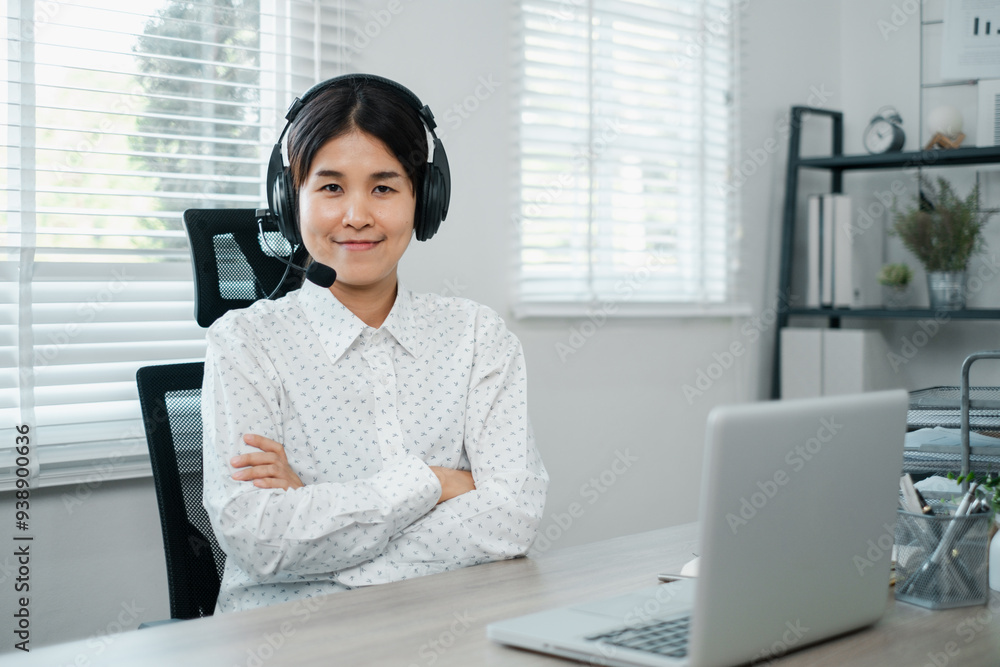 Professional woman wearing headset, working on laptop in a bright home office, ready for virtual meetings or customer support. Professional woman wearing headset, working on laptop in a bright home office, ready for virtual meetings or customer support.