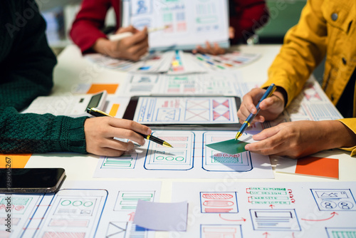 UX developer and ui designer brainstorming about mobile app interface wireframe design with customer breif and color code, User experience concept photo