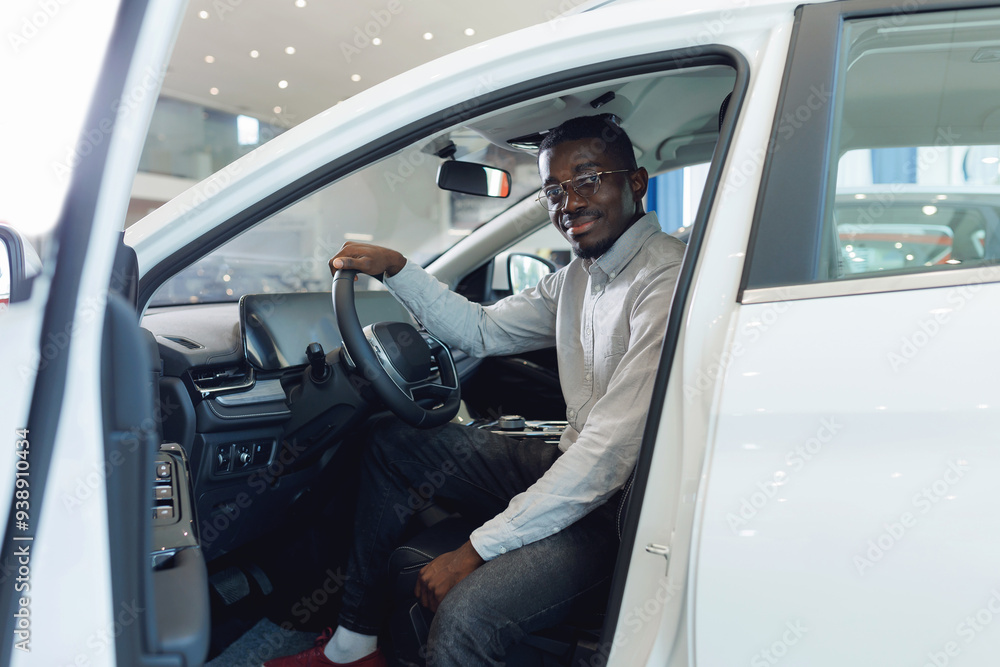 Handsome African American man customer client in suit get out car, touch door. Concept sales automobile in showroom vehicle store Handsome African American man customer client in suit get out car, touch door. Concept sales automobile in showroom vehicle store