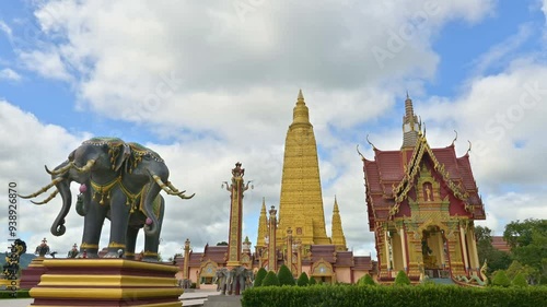 Amazing scene fast motion footage of a great golden pagoda with cloudy blue sky in buddhist temple. Wat Mahathat Wachiramongkhon or Wat Bang Thong, Krabi Province, Thailand.