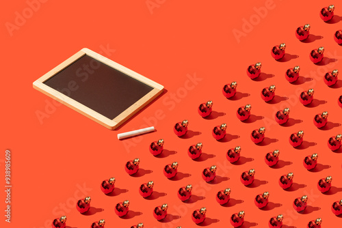 Blackboard mockup, template with christmas ball repetitive flat lay on red background photo