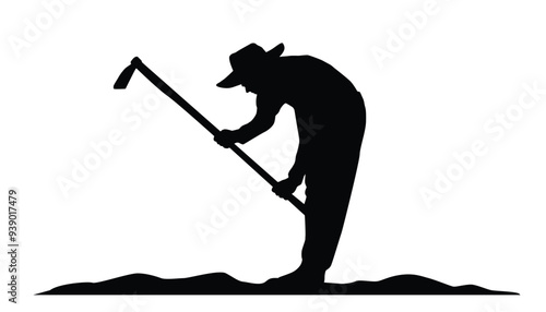 Silhouette of farmer hoeing the soil