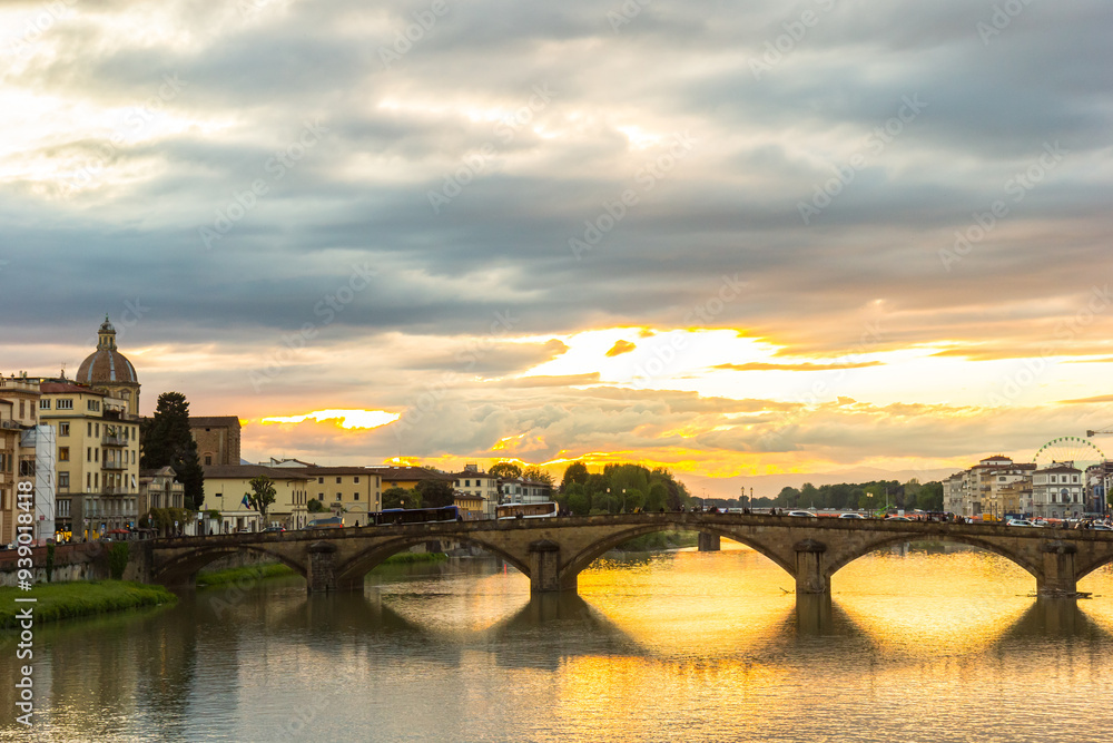 Colorful sunset over historic bridges in Florence, Italy