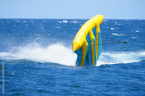 Parasailing with boat over sea in Barcelona
 in beautiful summer day. Tropical beach vacation.