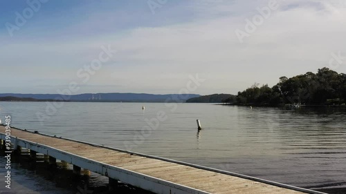 Boat jetty in Murrays beach on Lake Macquarie of Australia – aerial take off scene 4k.
 photo