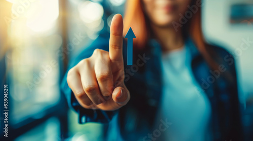 Close-up of a business woman pointing her finger at a virtual bright arrow. Concept of growth, development. Growing growth plan.