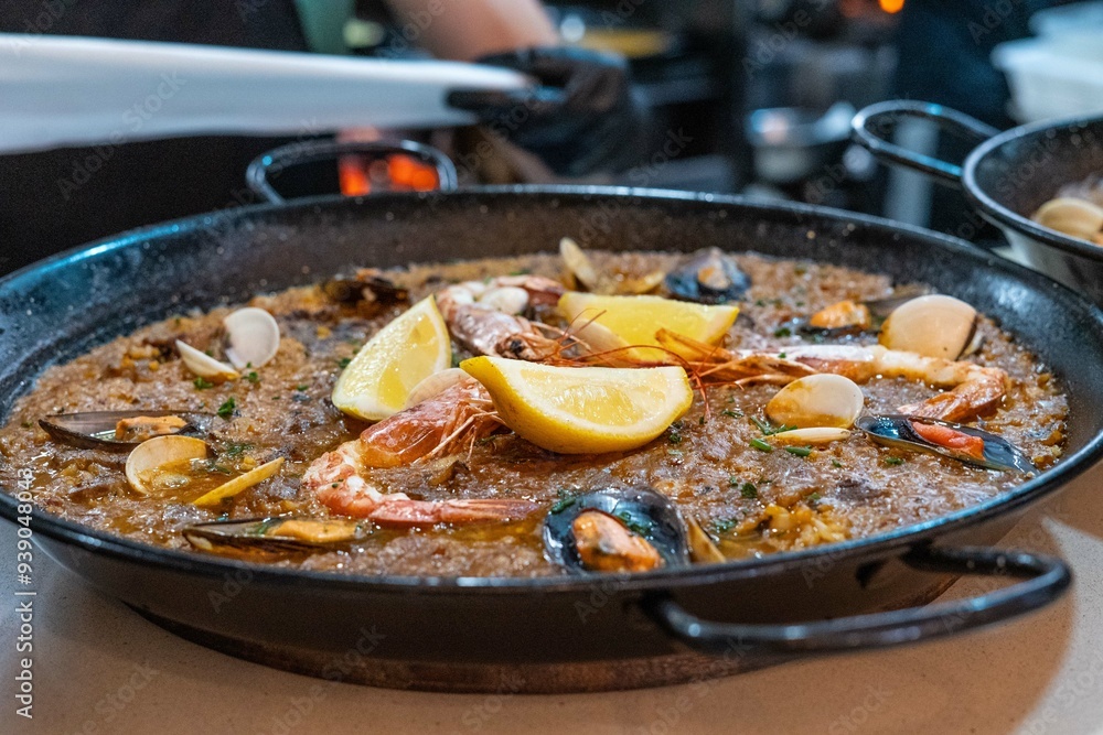 typical Spanish seafood paella, made with rice, seafood, pepper, saffron, mussels, prawns, lemon and snails typical Spanish seafood paella, made with rice, seafood, pepper, saffron, mussels, prawns, lemon and snails