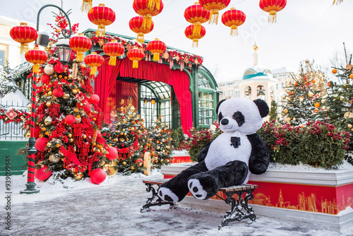 Plush stuffed pandas and Chinese red Christmas lanterns on Tverskaya Street in Moscow. Close-up. The first ever meeting of the Chinese New Year 2024 in Moscow. photo