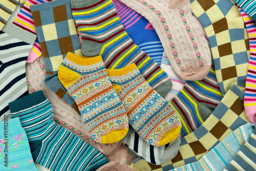 Multicolored socks. Background of bright and colorful socks. Knitted clothes in the form of socks.