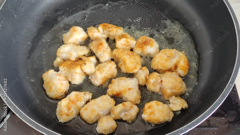 Chicken breast pieces are fried in a frying pan Chicken breast pieces are fried in a frying pan