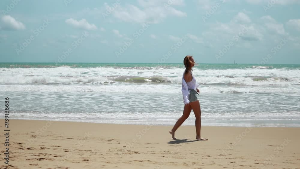 Young woman enjoy walk on beach. slow motion. Concept of seaside vacation beauty and serenity of moment Young woman enjoy walk on beach. slow motion. Concept of seaside vacation beauty and serenity of moment
