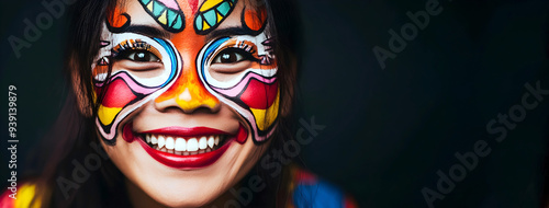 Smiling woman with vibrant and colorful face paint, celebrating in a festive mood