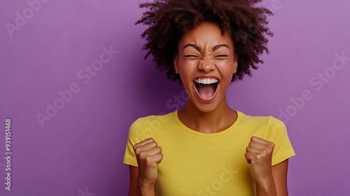 Life is wonderful Joyful dark skinned lady keeps fists clenched tilts head and exclaims in triumph celebrates success isolated over purple background with blank space for your advertis : Generative AI photo