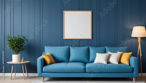 Interior mockup In a white room a blue sofa is placed next to a photo frame on the wall