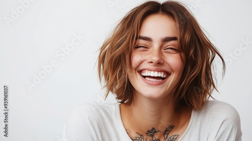 Happy European female laughs joyfully shows white teeth has bobbed hairstyle dressed in casual t shirt has tattoo isolated over white background recieves pleasant compliment Emotions : Generative AI photo