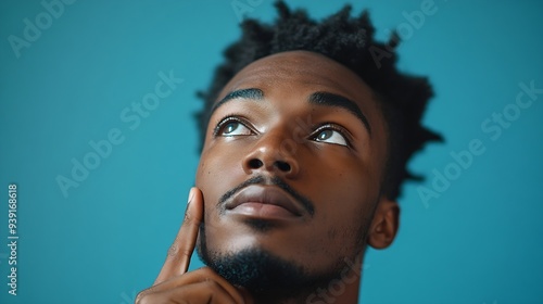 Human face expressions emotions and feelings Handsome young African American man looking up with thoughtful and skeptical expression holding finger on his chin trying to remember somet : Generative AI