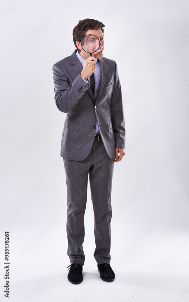 Portrait, smile and businessman with magnifying glass, investigator and audit at company on white studio background. Face, male employee and PI with compliance and fair trade evidence or information Portrait, smile and businessman with magnifying glass, investigator and audit at company on white studio background. Face, male employee and PI with compliance and fair trade evidence or information