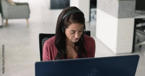 Helpline center employee sit at desk with pc, lead talk to client, provides products or services information by answering questions, offering assistance, conduct issues options and solutions remotely photo