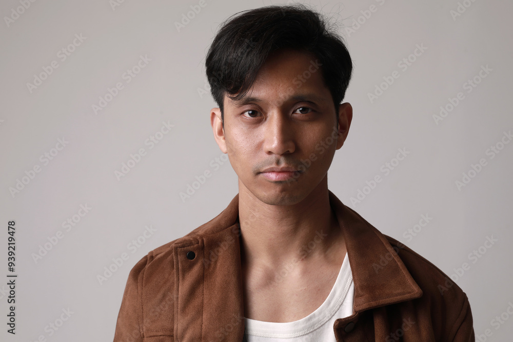Studio portrait of asian young man, posing over white wall. Studio portrait of asian young man, posing over white wall.