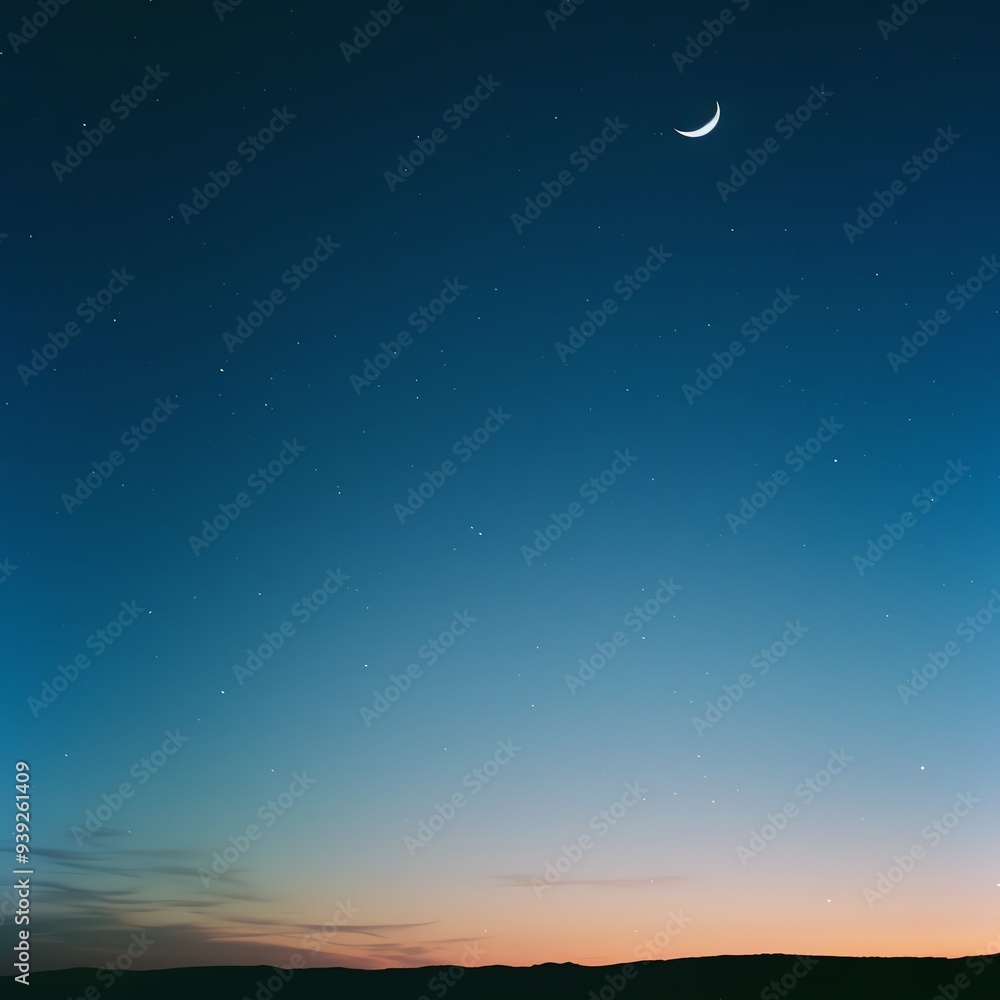 Scenic view of a crescent moon against a clear night sky with a beautiful twilight horizon and subtle gradient of colors from blue to orange. Scenic view of a crescent moon against a clear night sky with a beautiful twilight horizon and subtle gradient of colors from blue to orange.