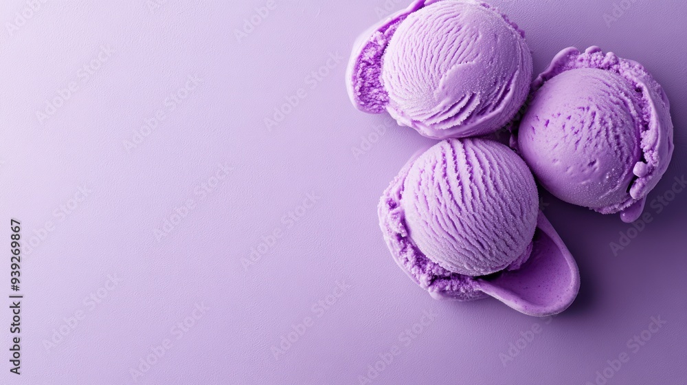 Three scoops of purple ice cream on a purple background, with a spoon. Three scoops of purple ice cream on a purple background, with a spoon.