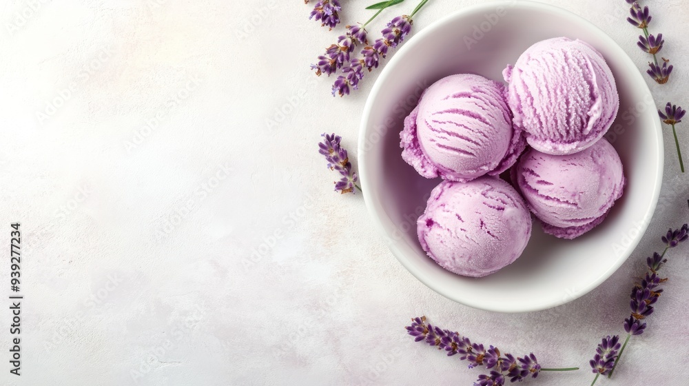 Top view of a white bowl with three scoops of lavender ice cream, surrounded by lavender flowers, on a white background. Top view of a white bowl with three scoops of lavender ice cream, surrounded by lavender flowers, on a white background.