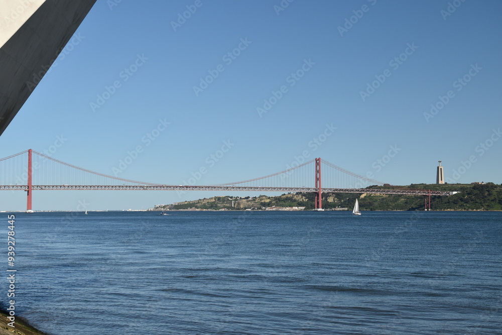 Naklejka premium Suspension bridge crossing the river Tagus in Lisbon Portugal. The 25 de Abril Bridge. 